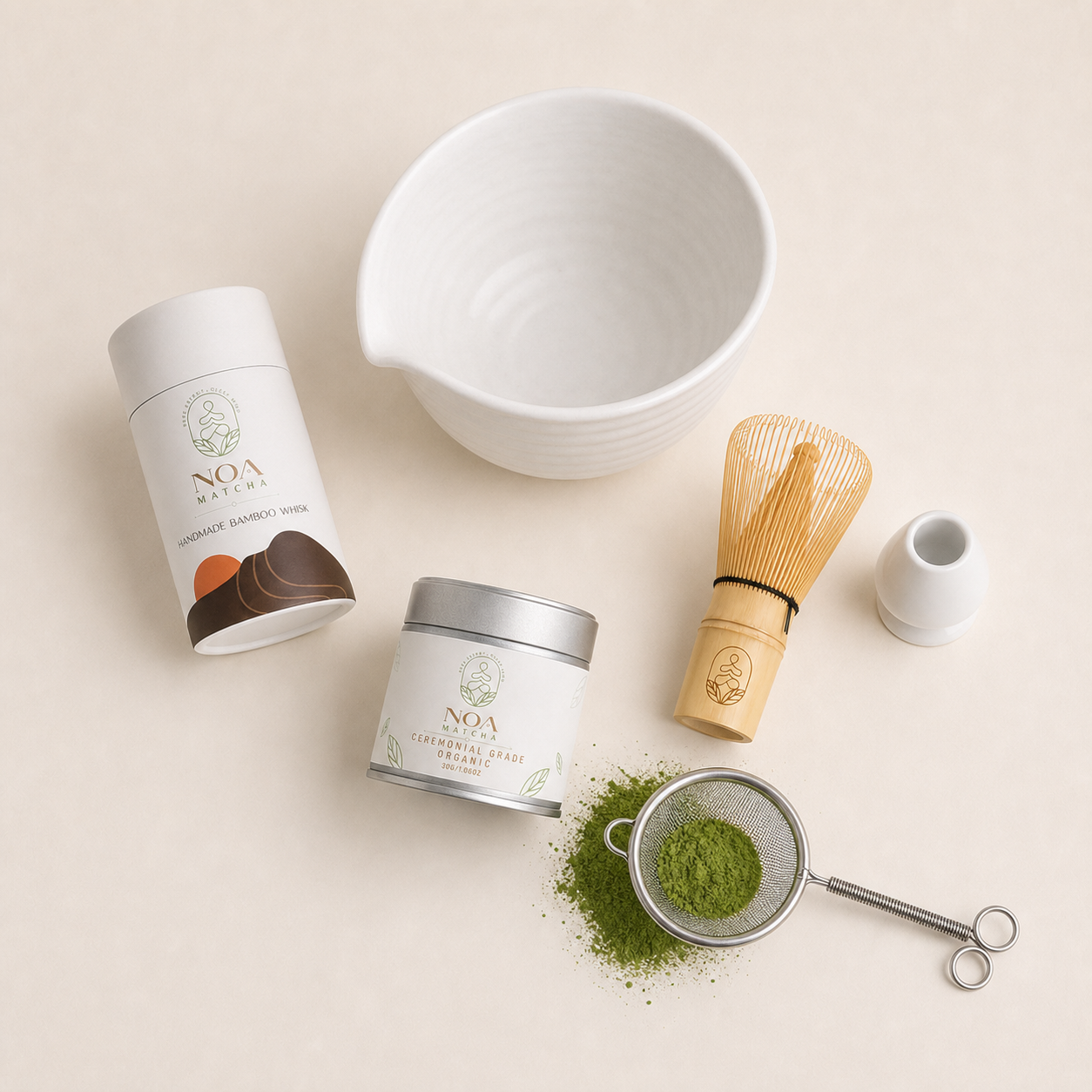 Flat-lay of the NOA Matcha complete organic set — tin, bowl, whisk, holder and sifter with sifted matcha
